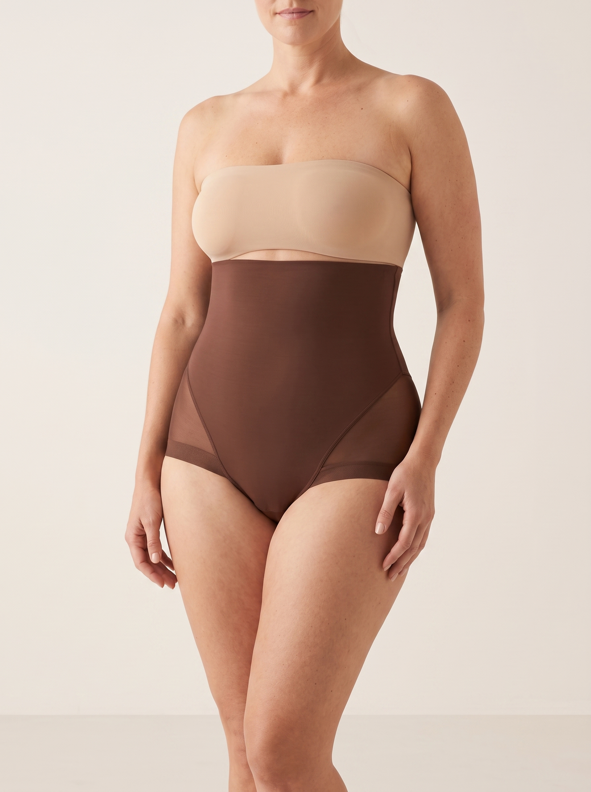 AI-generated model wearing the AirCurve mesh-panel high-waist shaping brief in Brown, front three-quarter view