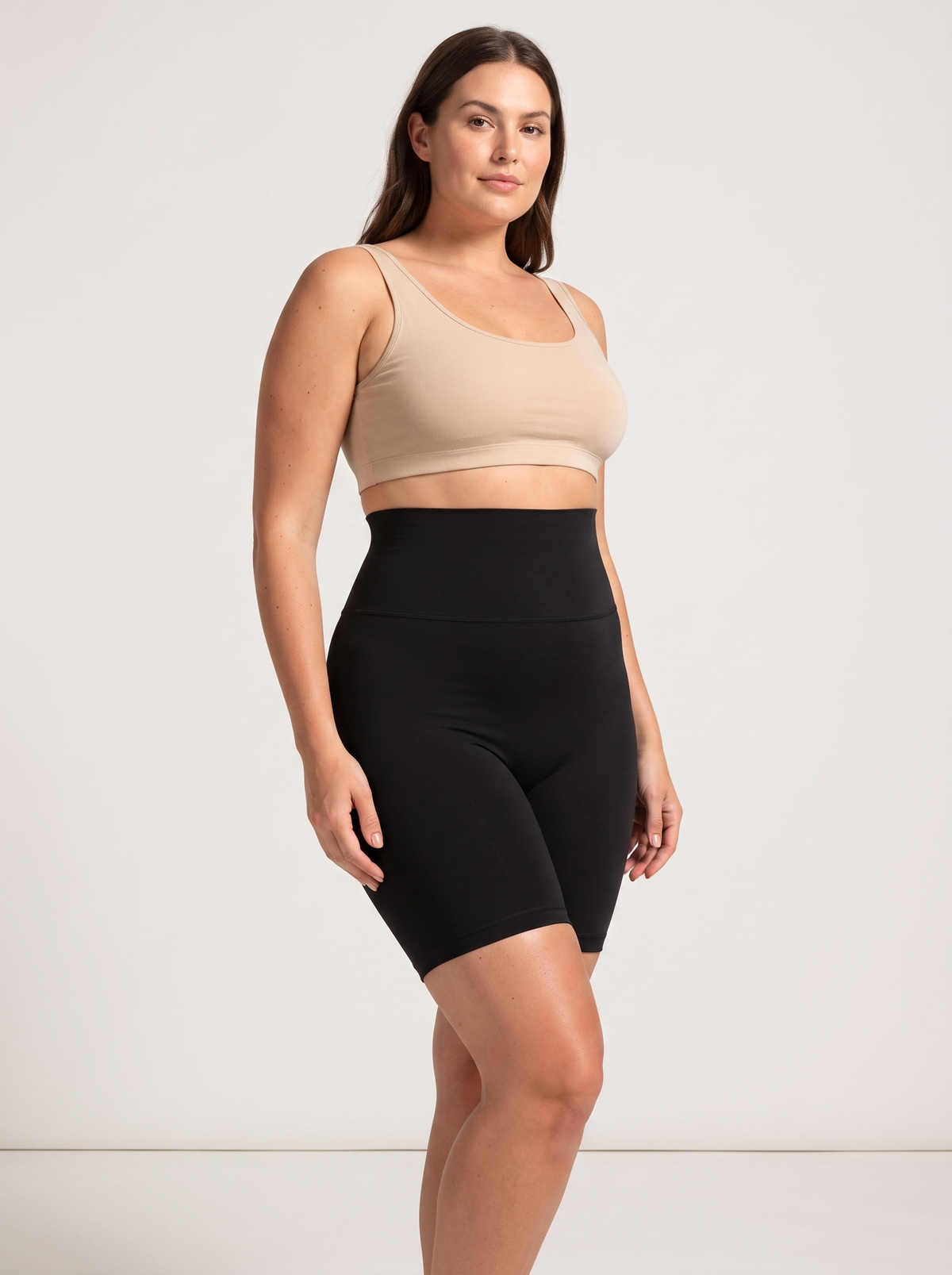 AI-generated model wearing the Everyday Sculpt high-waist mid-thigh shorts in Black, front three-quarter view