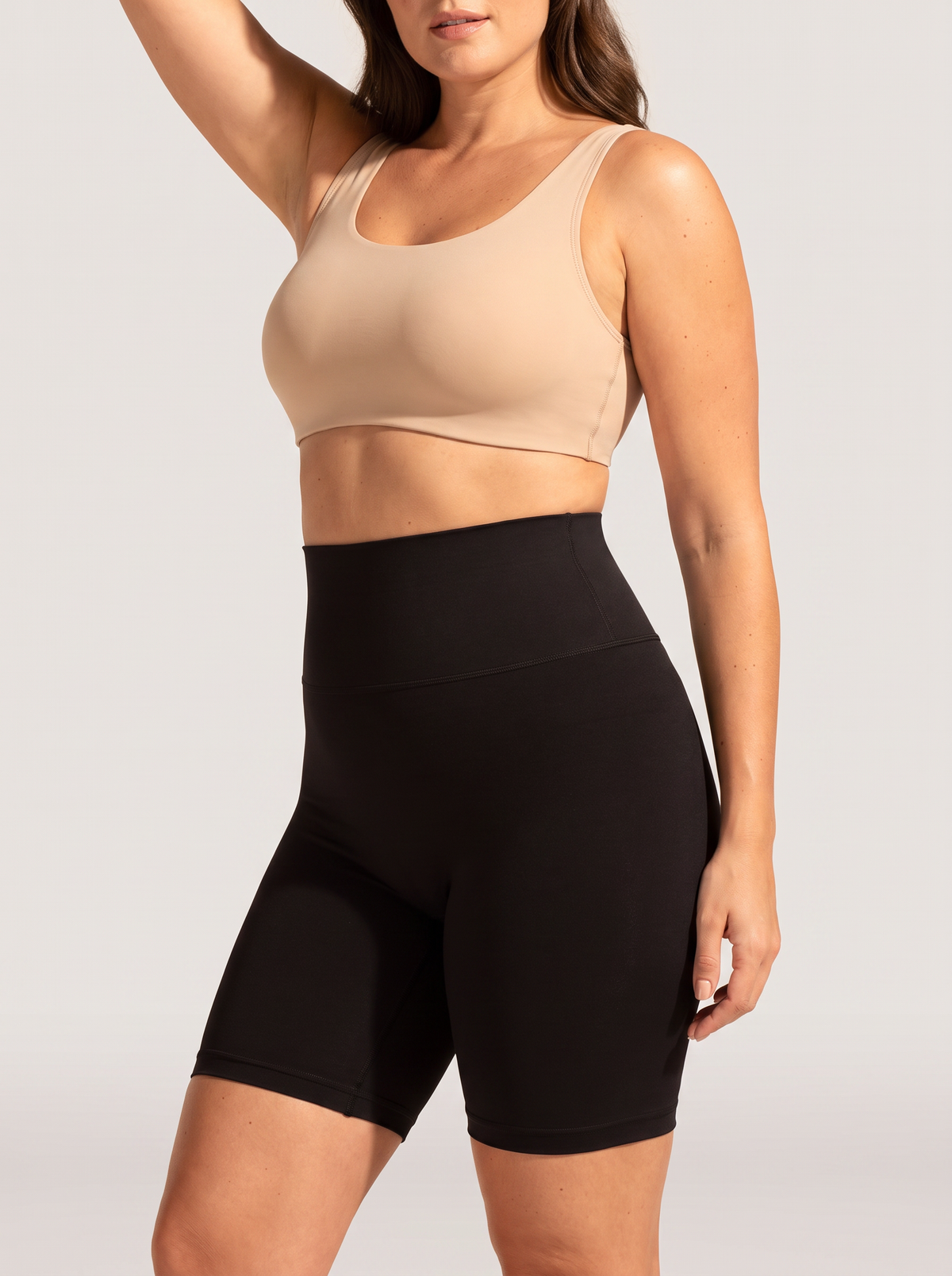 AI-generated model wearing the Everyday Sculpt high-waist mid-thigh shorts in Black, side view view