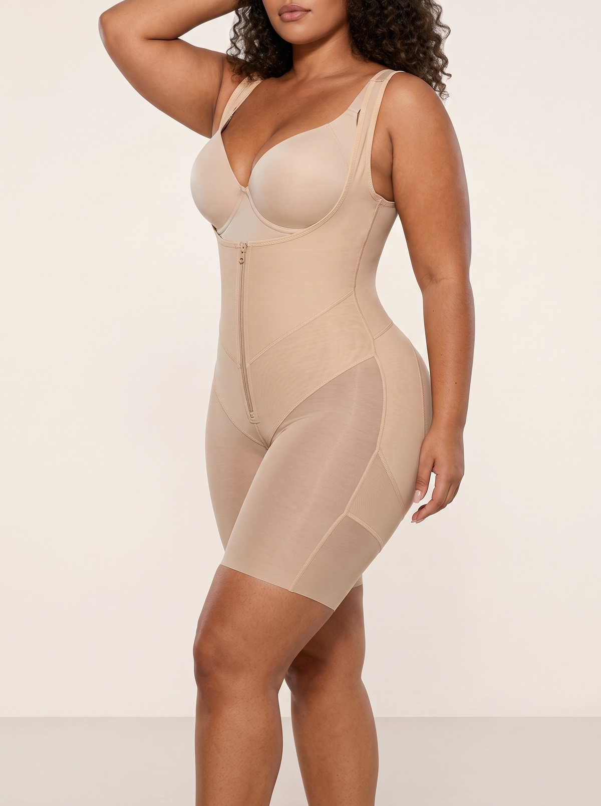 AI-generated model wearing the FlexFit open-bust zip-front mid-thigh bodysuit in Beige, side view view