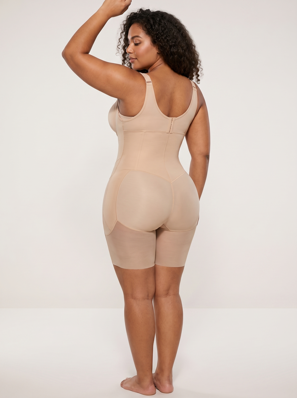 AI-generated model wearing the FlexFit open-bust zip-front mid-thigh bodysuit in Beige, back three-quarter view